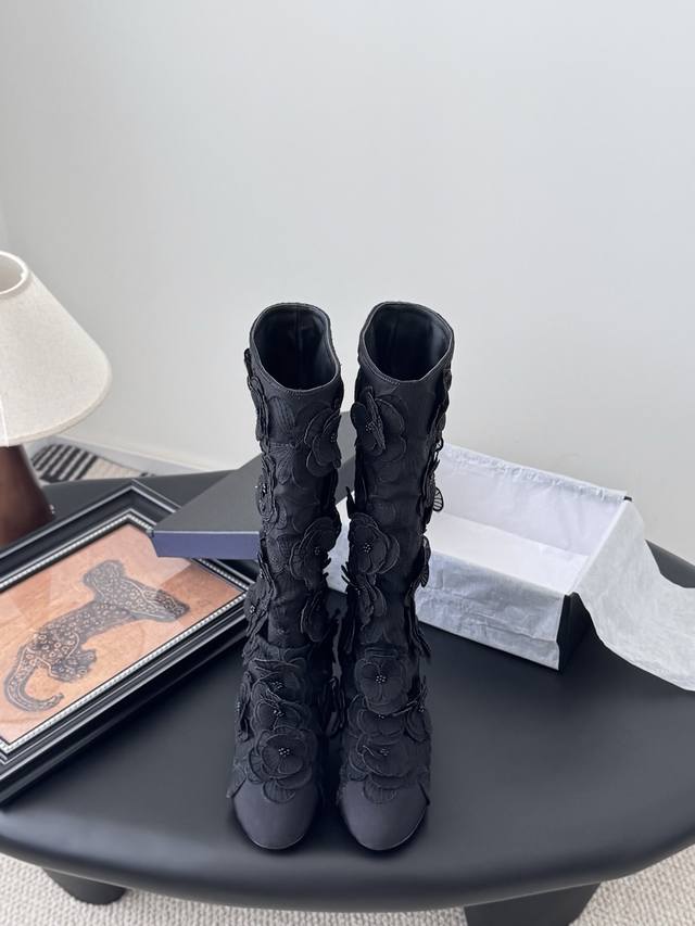 Chanel 25p new Camellia boots . Each delicate flower is embellished with a tiny