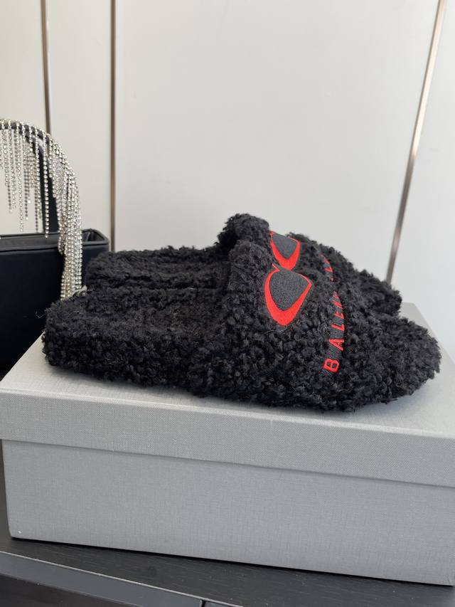 Balenciaga's new Teddy Bear furry slippers. These cola-embroidered twill brushe