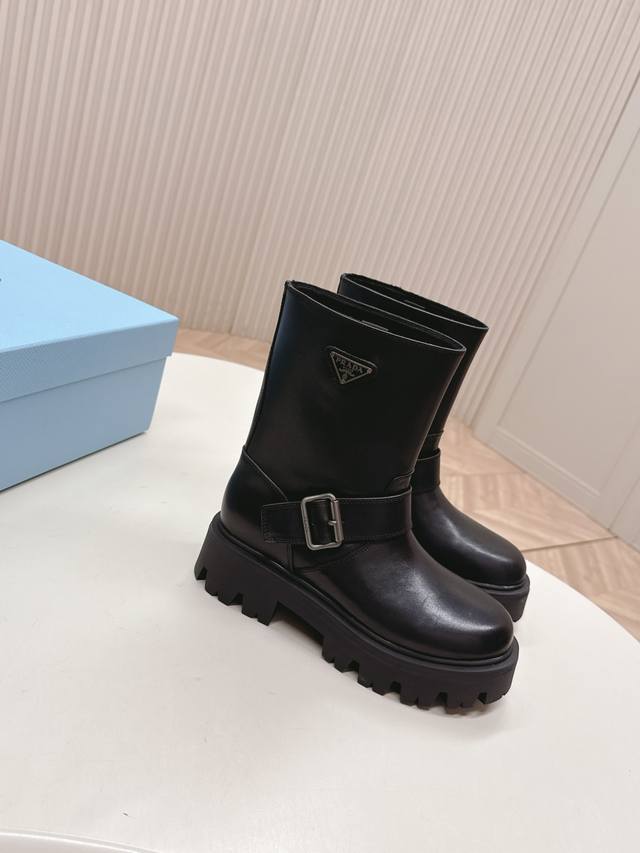 is releasing leather ankle boots. These Prada classic triangle-shaped slip-on b