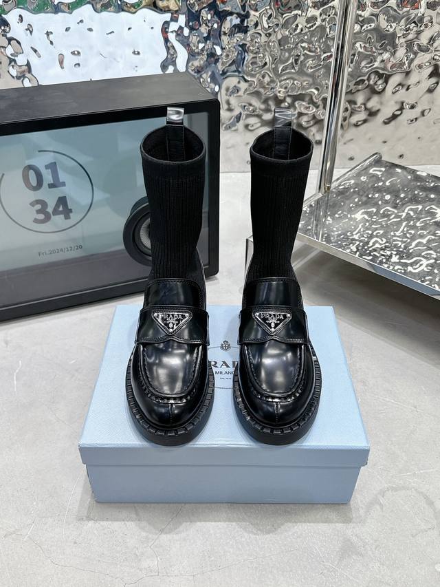 Prada's classic triangle logo socks and loafers are incredibly wearable! Known a