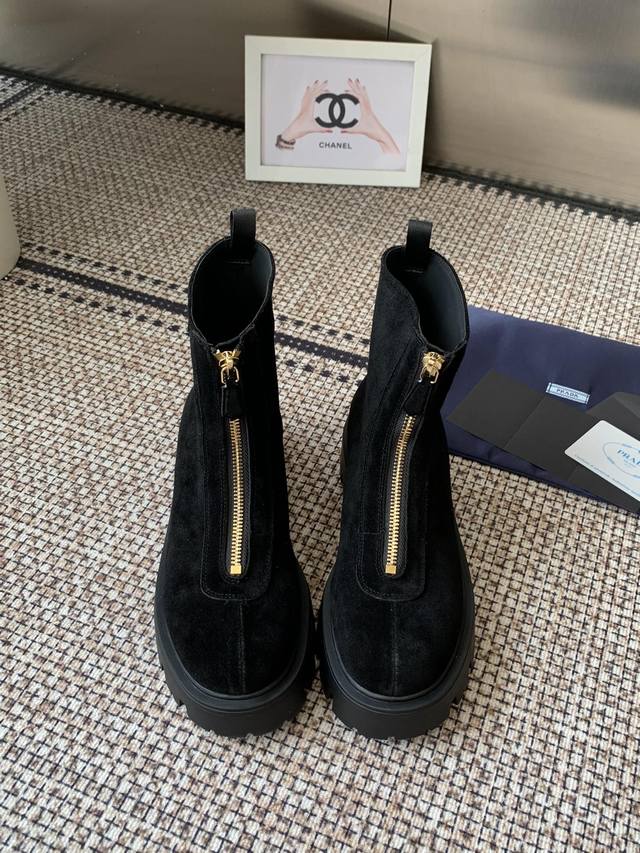 Prada 25Ss classic triangle logo slip-on boots for women. A must-have this winte