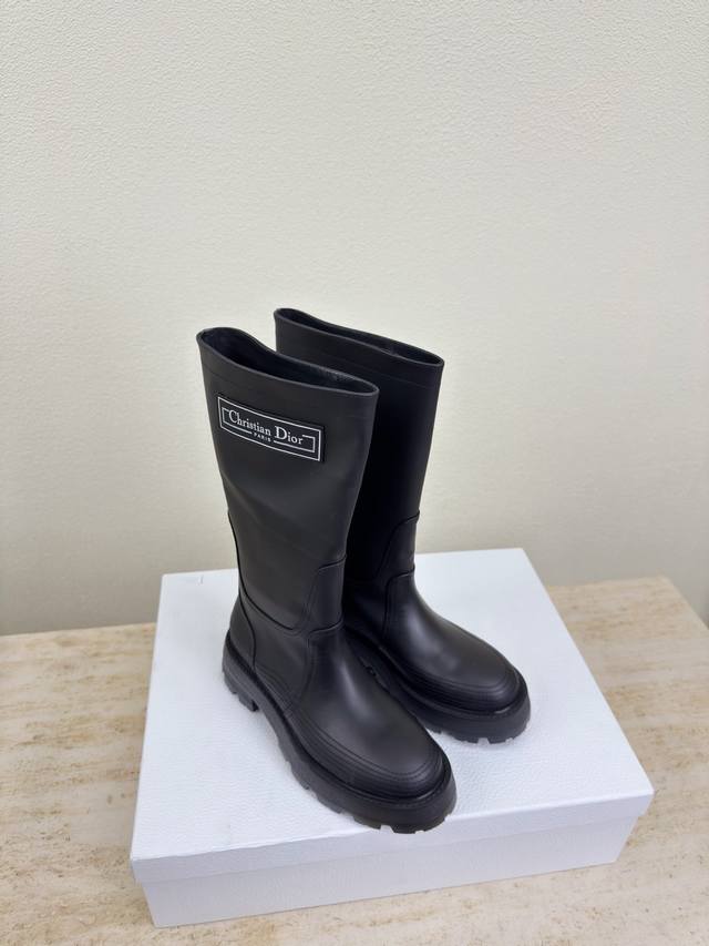 Dior motorcycle boots with thick lines and rubber logo. , consistent with the o