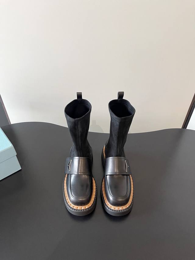 Prada's latest stretch-soled motorcycle boots and bags are stylish and casual.