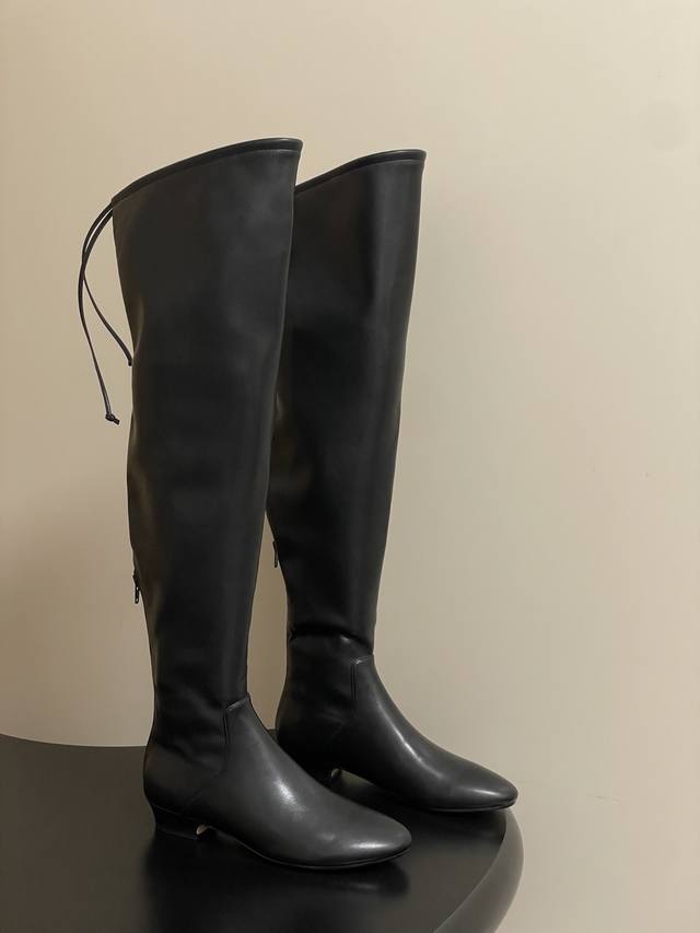 The Row's new 2025 Early Fall Tr stretch over-the-knee boots with a low-heeled h