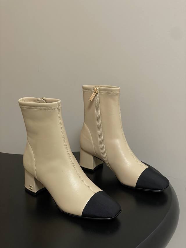 A timeless classic Chanel style. These square-toed, side-zippered stretch ankle