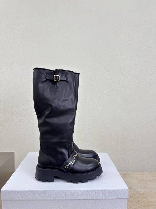 Dior knee-high boots with thick sole and metal logo decoration. Original design.
