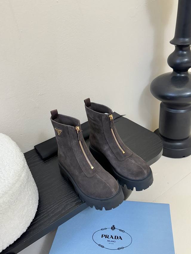 Prada classic triangle logo slip-on women's boots. A must-have for winter, this