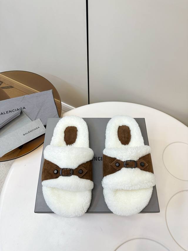 Balenciaga furry mules! These Balenciaga furry mules feature a white lamb's wool