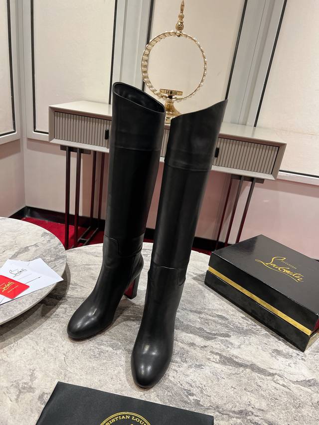 The Jane Booty features a square, 85mm sloping heel and is crafted from black ca