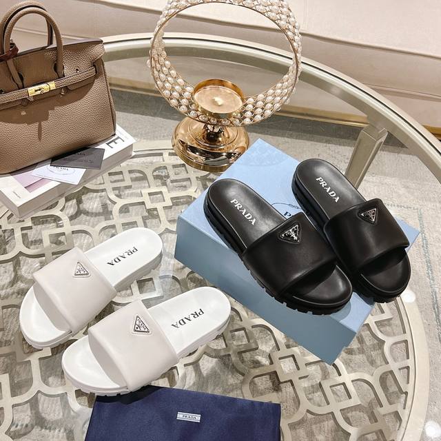 Prada's new triangular logo showcases the brand's iconic element. Made with impo