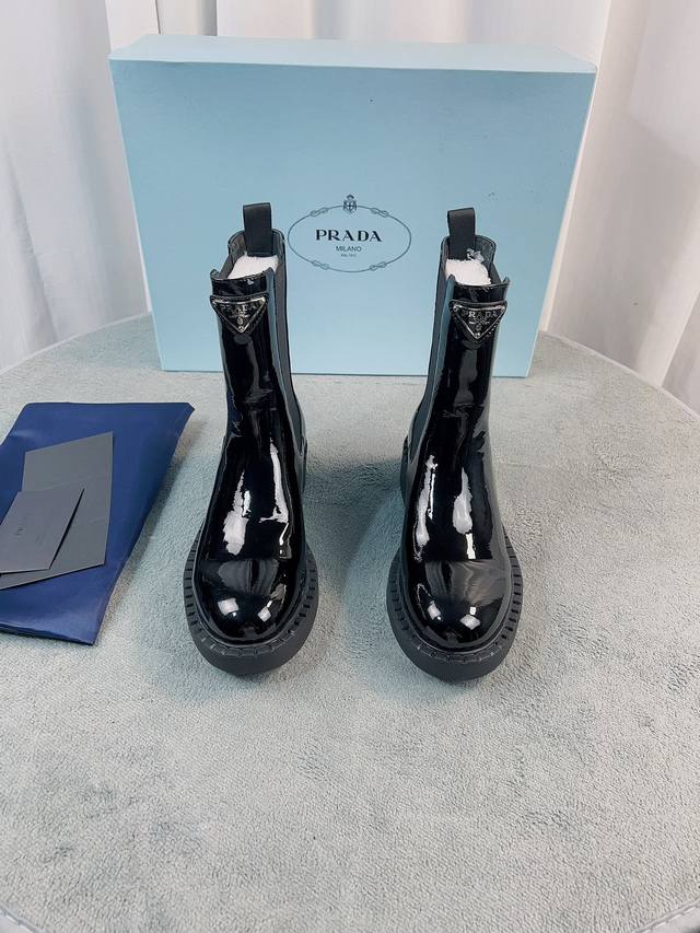 Prada's latest ankle boot series. Upper: Imported calfskin, patent leather, spli
