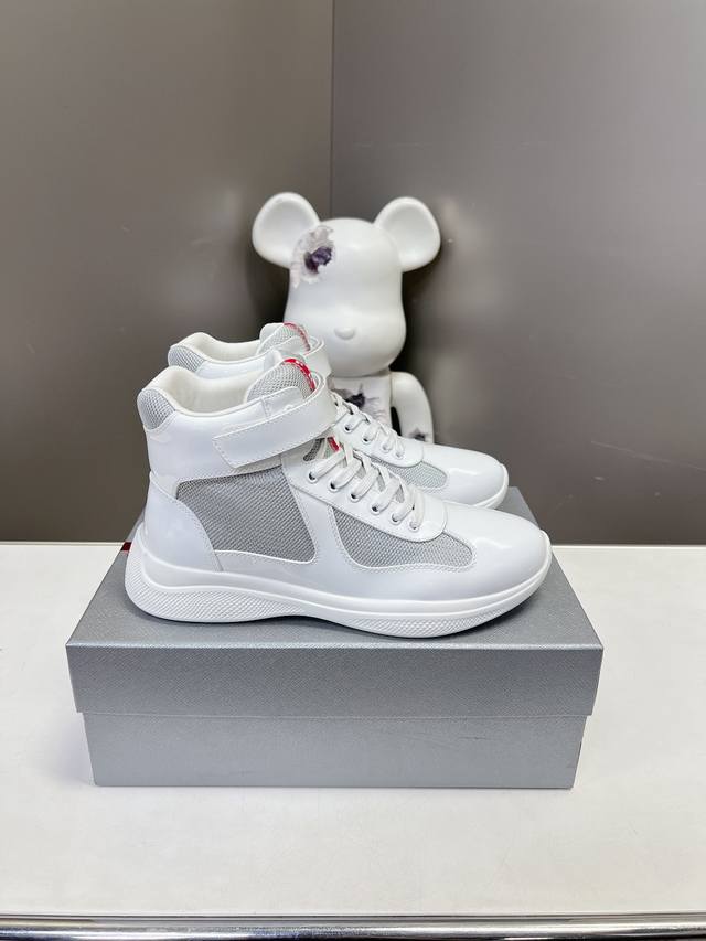 Prada premium high-top sneakers. Features include an imported flyknit upper with