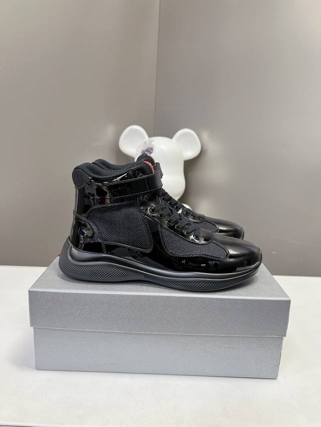 Prada premium high-top sneakers. Features include an imported flyknit upper with