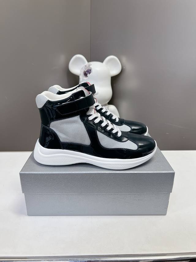 Prada premium high-top sneakers. Features include an imported flyknit upper with