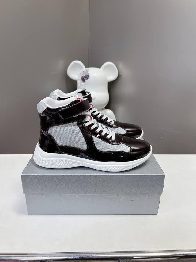 Prada premium high-top sneakers. Features include an imported flyknit upper with