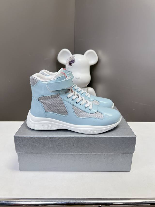 Prada premium high-top sneakers. Features include an imported flyknit upper with
