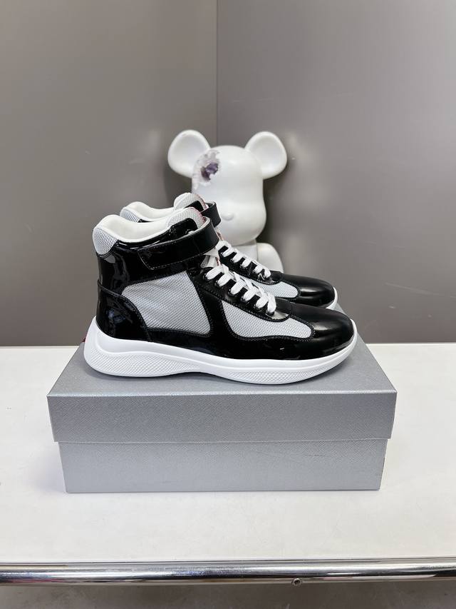 Prada premium high-top sneakers. Features include an imported flyknit upper with