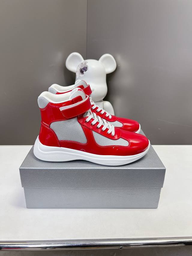 Prada premium high-top sneakers. Features include an imported flyknit upper with