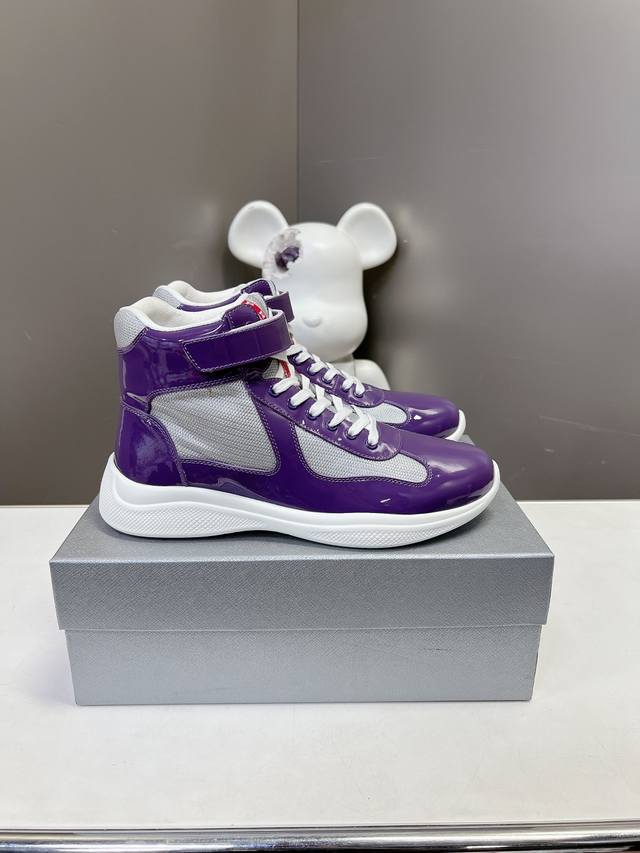 Prada premium high-top sneakers. Features include an imported flyknit upper with