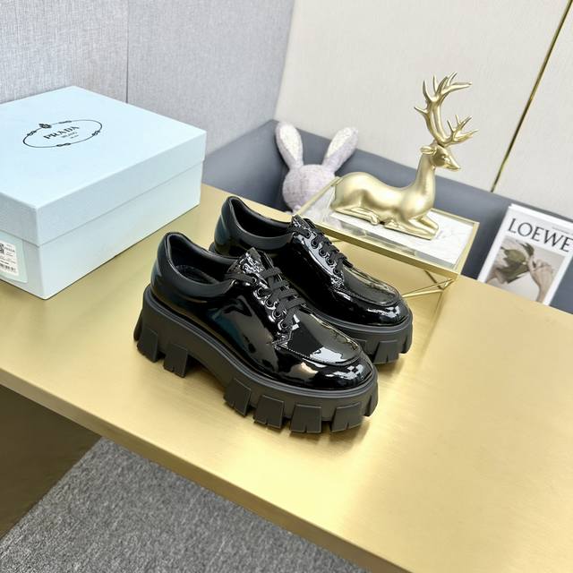 Top-tier version, Prada patent leather lace-up platform loafers. Upper: Enameled