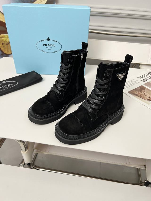 Prada's classic triangle logo Dr. Martens boots. This year's hottest style. Styl