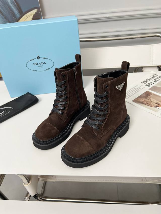 Prada's classic triangle logo Dr. Martens boots. This year's hottest style. Styl