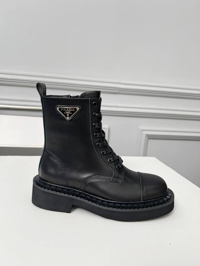 Prada's classic triangle logo Dr. Martens boots. This year's hottest style. Styl