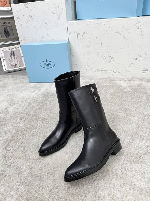 Top-tier luxury version of the classic Prada triangle logo pointed-toe boots. Pr