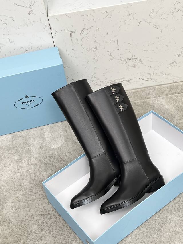 Top-tier luxury version of the classic Prada triangle logo pointed-toe boots. Pr
