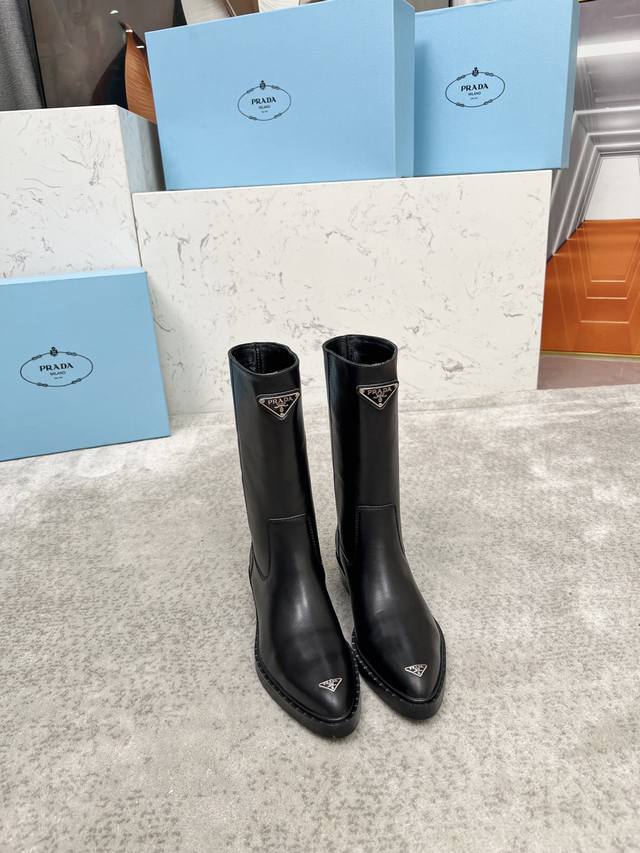 Top-tier luxury version of the classic Prada triangle logo pointed-toe boots. Pr