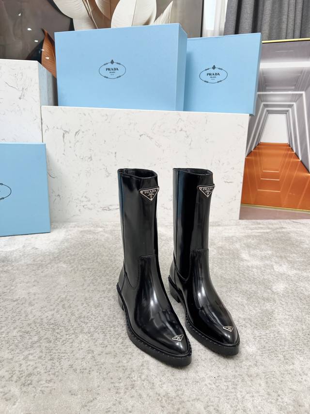 Top-tier luxury version of the classic Prada triangle logo pointed-toe boots. Pr