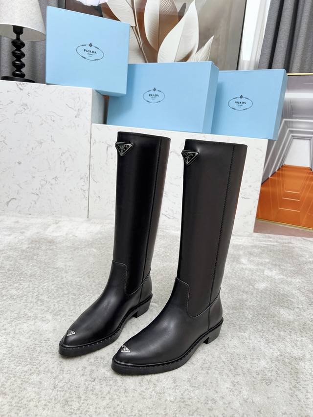 Top-tier luxury version of the classic Prada triangle logo pointed-toe boots. Pr