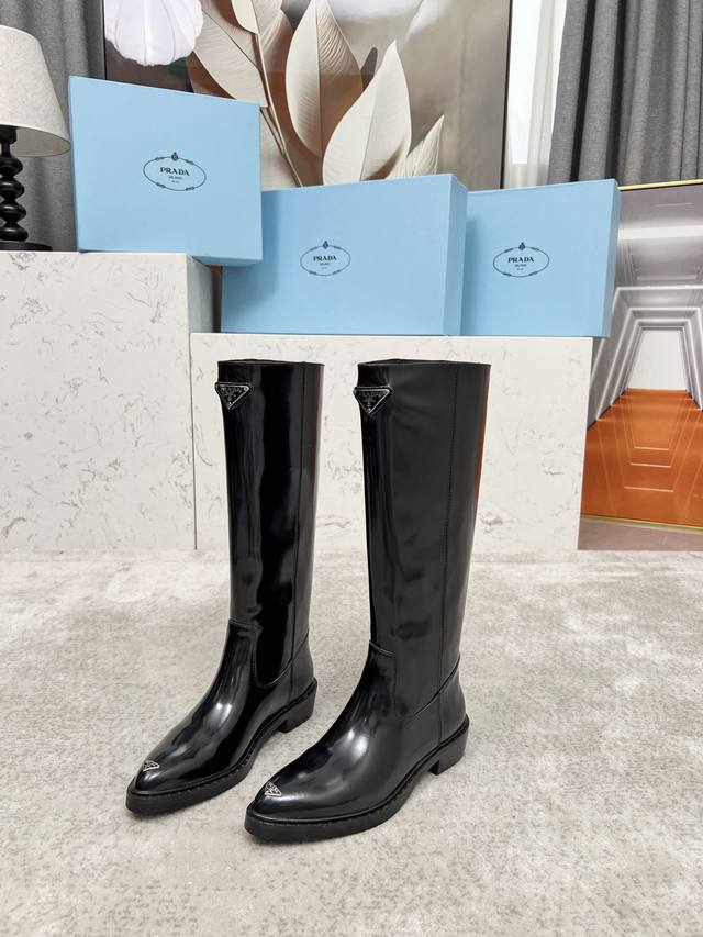 Top-tier luxury version of the classic Prada triangle logo pointed-toe boots. Pr