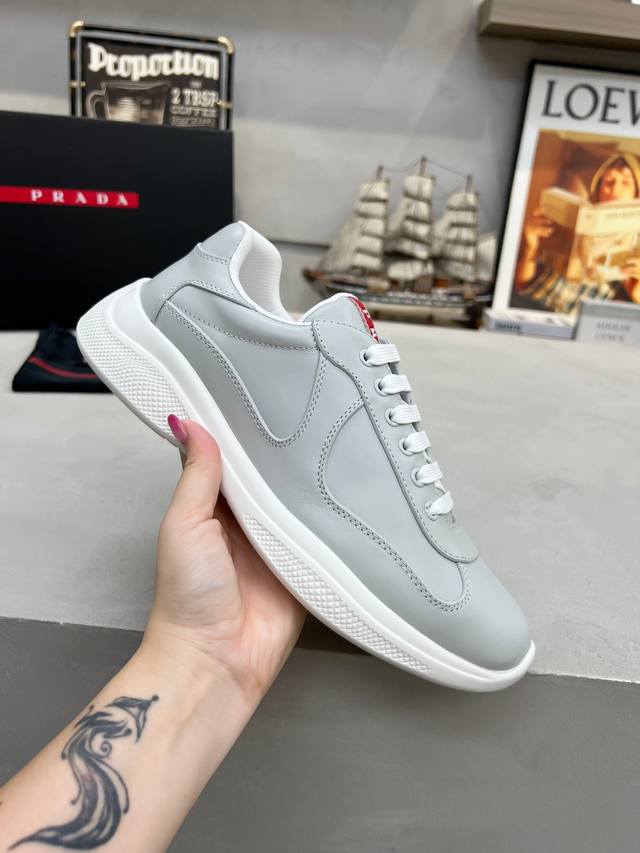 Prada Top-Tier Sneakers. Features include an imported flyknit upper with patent