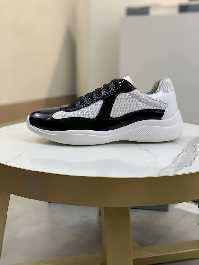 Prada premium edition sneakers. Features include an imported flyknit upper with
