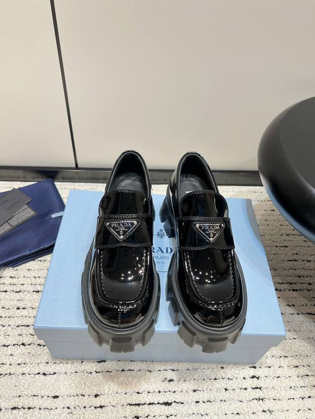 Dongguan-made Prada retro loafers with a triangle logo. The triangle logo metal