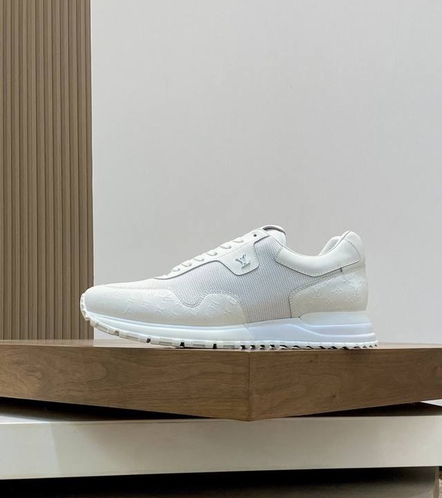 Newest Louis Vuitton men's sneakers with embossed pattern and black mesh. Class