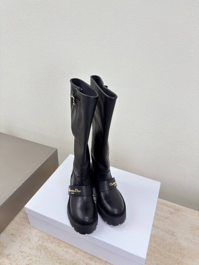 Dior knee-high boots with thick sole and metal logo decoration. Original design