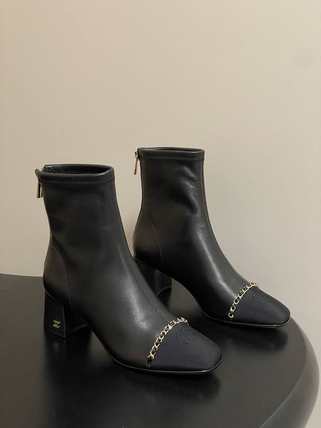 A timeless classic Chanel classic chain square toe chunky heel ankle boot with b