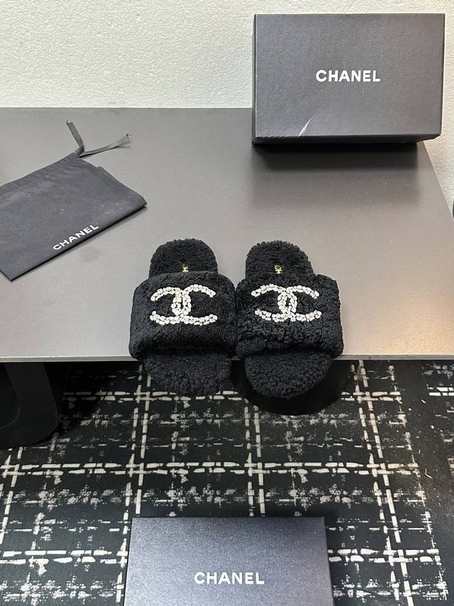 Chanel's latest 25-inch plush, rhinestone-embellished flat wool slippers are now