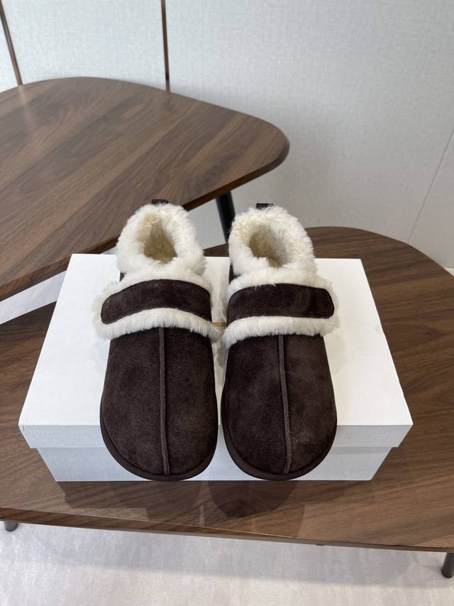 The Row sheepskin boots, featuring a simple and convenient Velcro design that lo