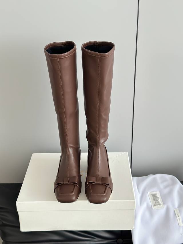 The Row25Ss Retro Square Toe Bow Knee Tall Boots Continuing the brand's "minimal