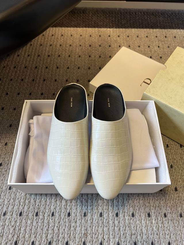 The Row 25Ss Embossed Leather Flat Mule Slippers The embossed leather features a