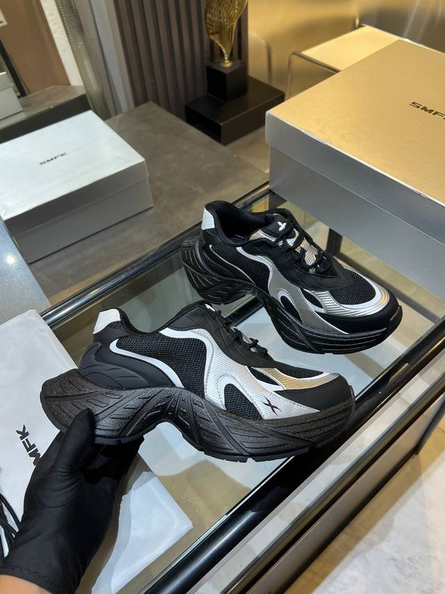 Smfk brand chunky sneakers feature a black and white color-blocked upper with a