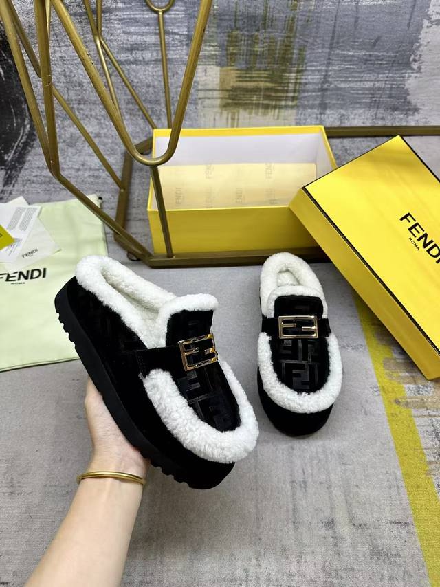 Fendi's latest casual round-toe flat mules. Made of black suede with a tonal em