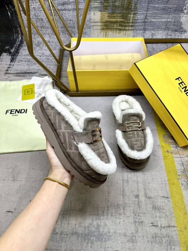 Fendi's latest casual round-toe flat mules. Made of grey suede with a tonal emb