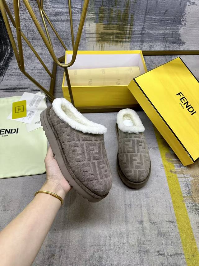 Fendi's latest round-toe unisex flat mules. Made with grey suede embossed with