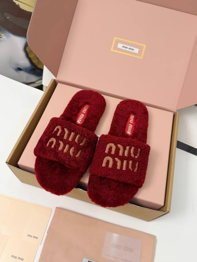 Miumiu flat fluffy slippers. The fluffy material wraps around your feet, making