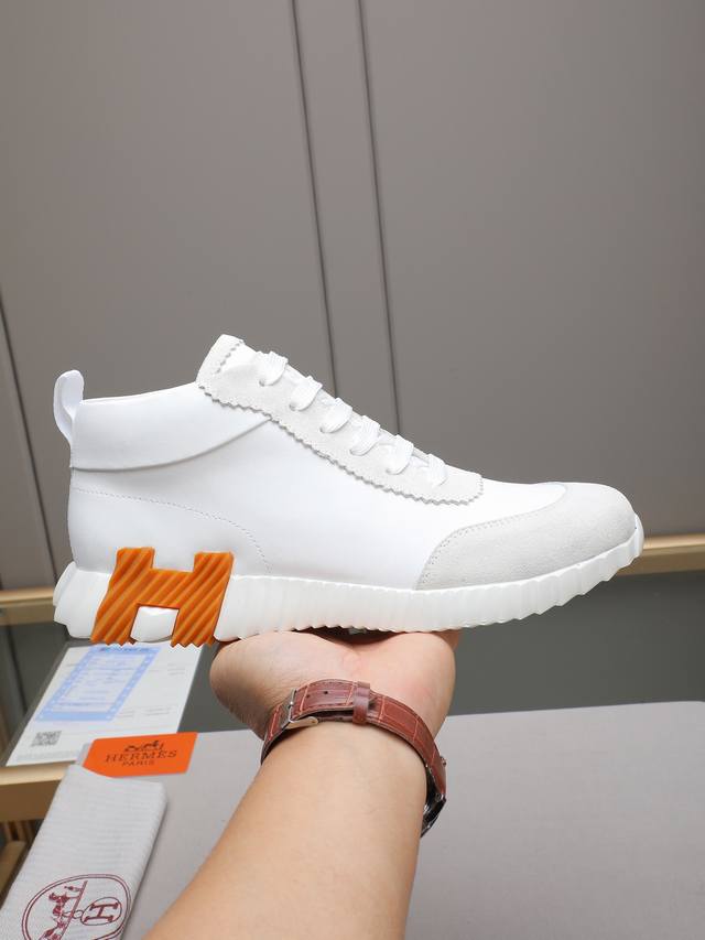 pp Hermes high-top men's sneakers, featuring textured calfskin details. The uppe
