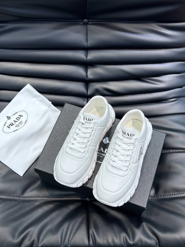 prad* Men's New Soft Leather Casual Sneakers. These sneakers are crafted from Na